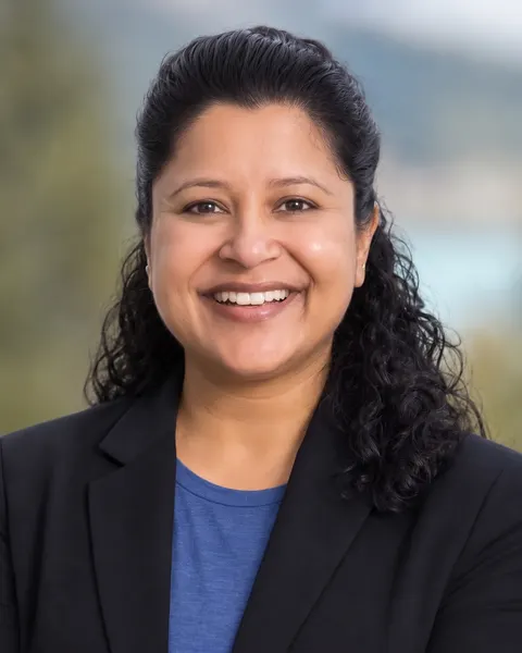 Sweta Patel, smiling, in a dark blazer